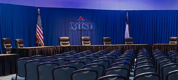 A picture of the school board seats before a meeting