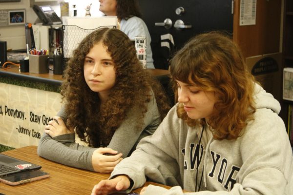 Two students working in a club