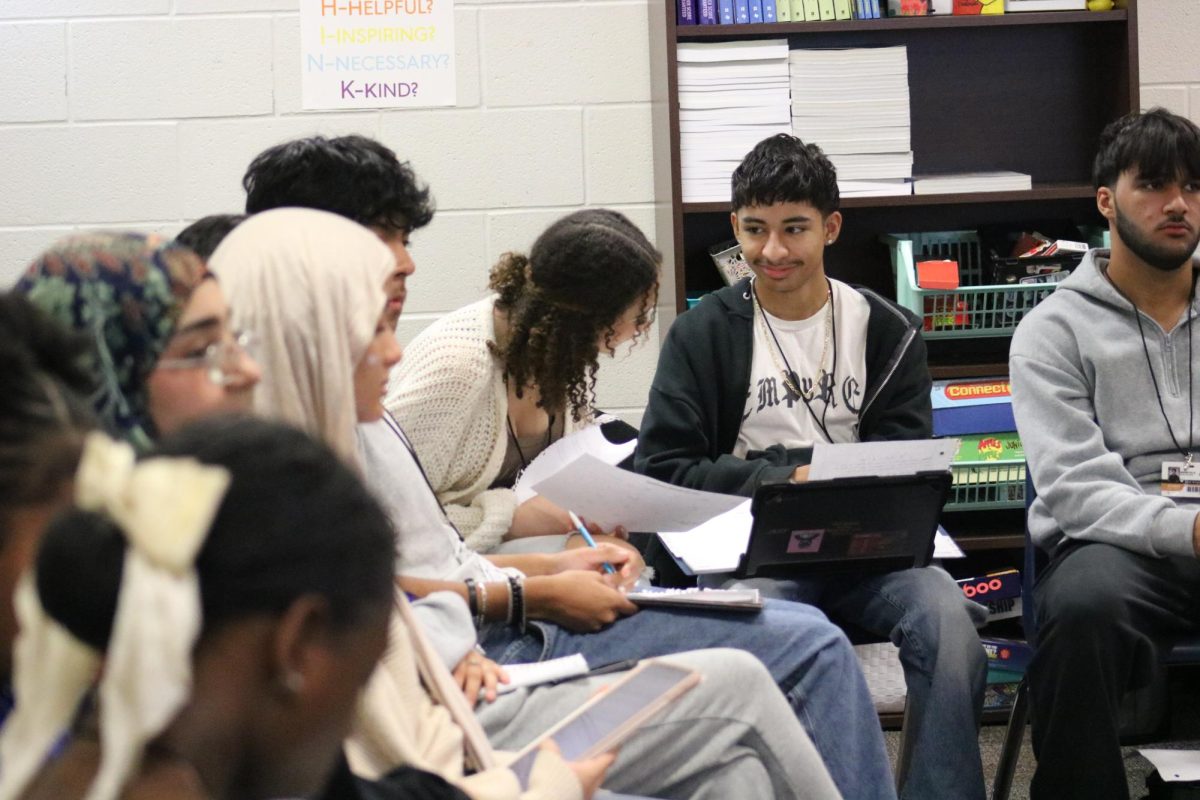 AVID students talking over classwork 